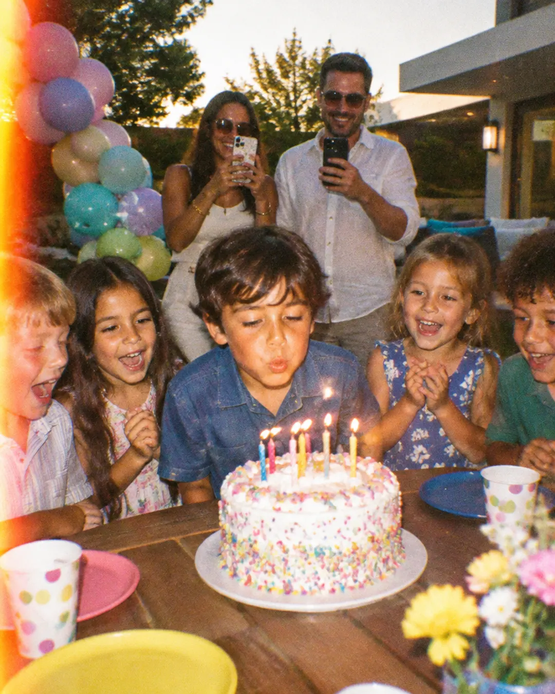 Kids around a birthday cake